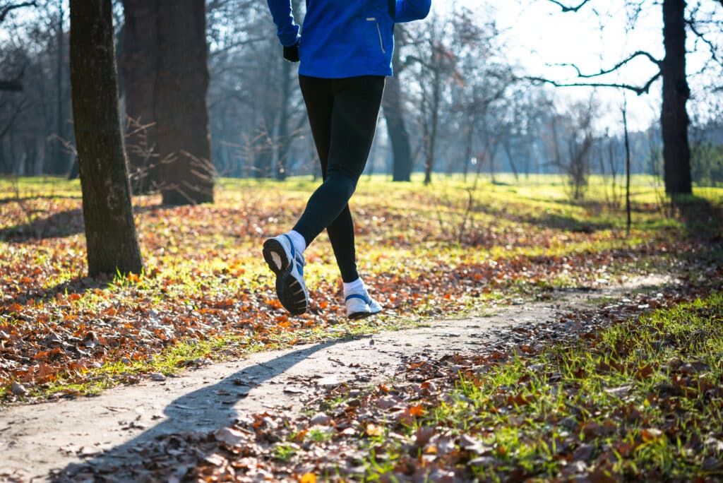 Young,Sports,Man,Running,In,The,Park,In,Cold,Sunny